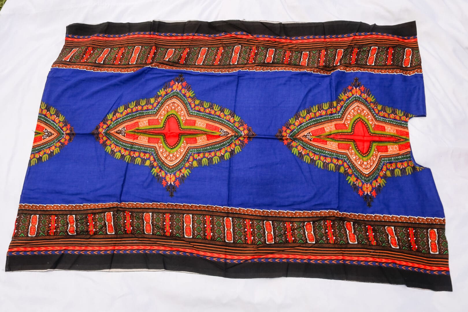 A blue and red blanket with an ornate design.