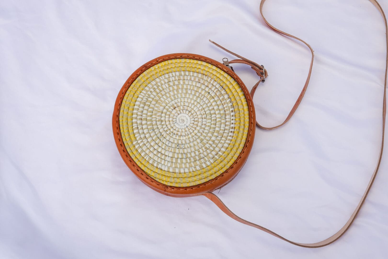 A round bag with a yellow and orange pattern on it.